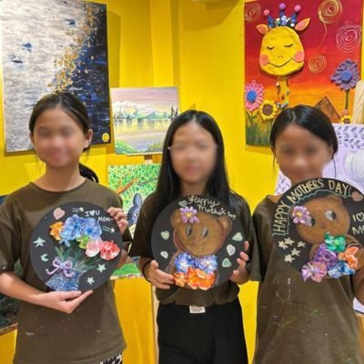Students holding their seasonal crafts